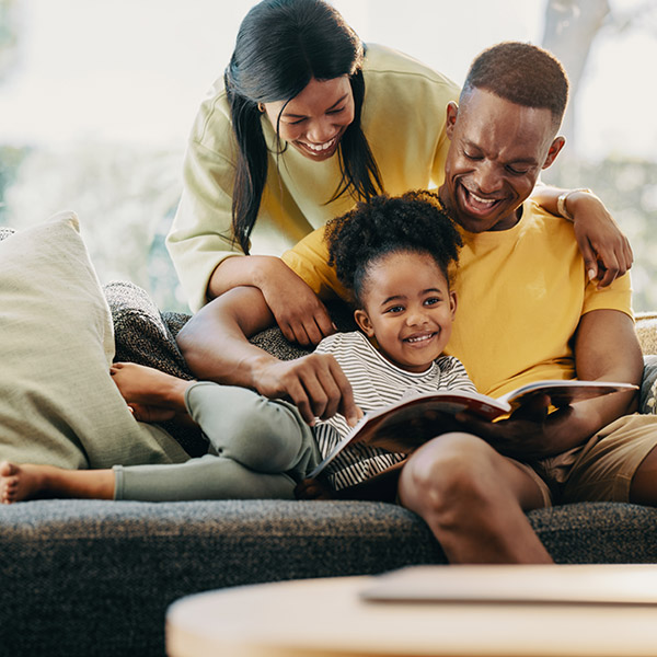 Family Reading Together on the Couch After Dryer Vent Cleaning in Edmonton & Spruce Grove