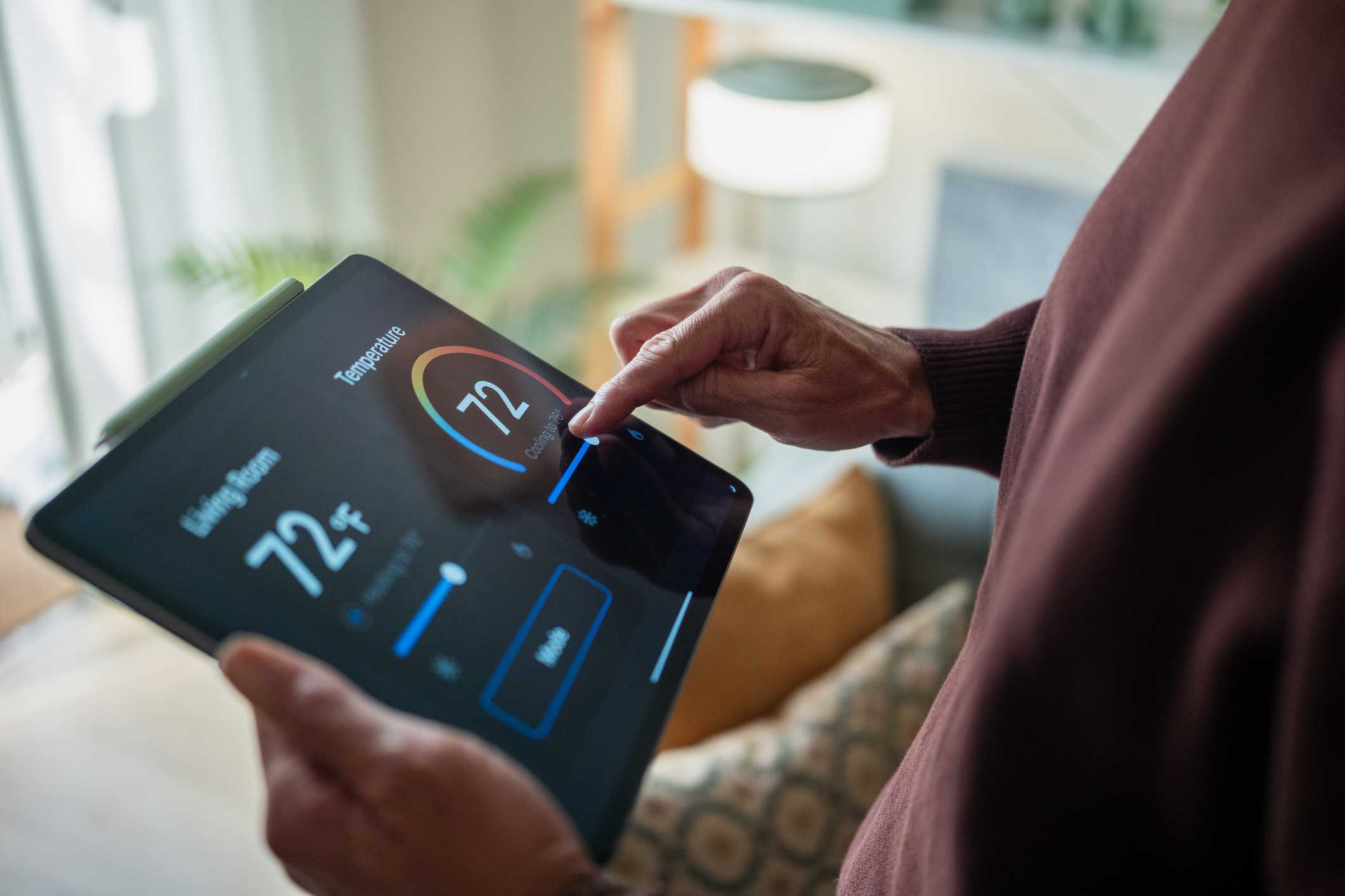 Smart thermostat control on tablet in Spruce Grove, AB home